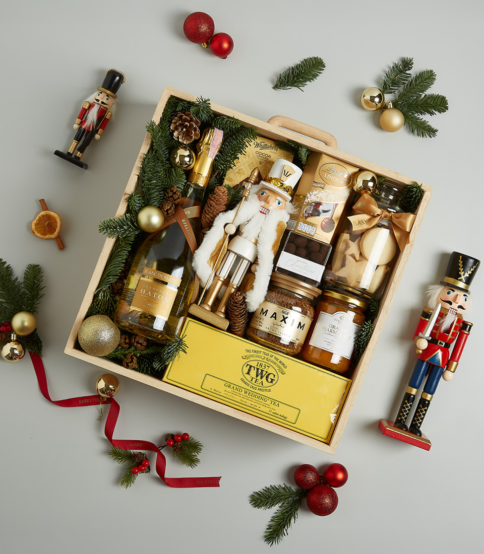Christmas gift hamper with Bottega Gold prosecco, TWG tea, gourmet honey, artisanal cookies, chocolates, and Nutcracker decoration in festive packaging.