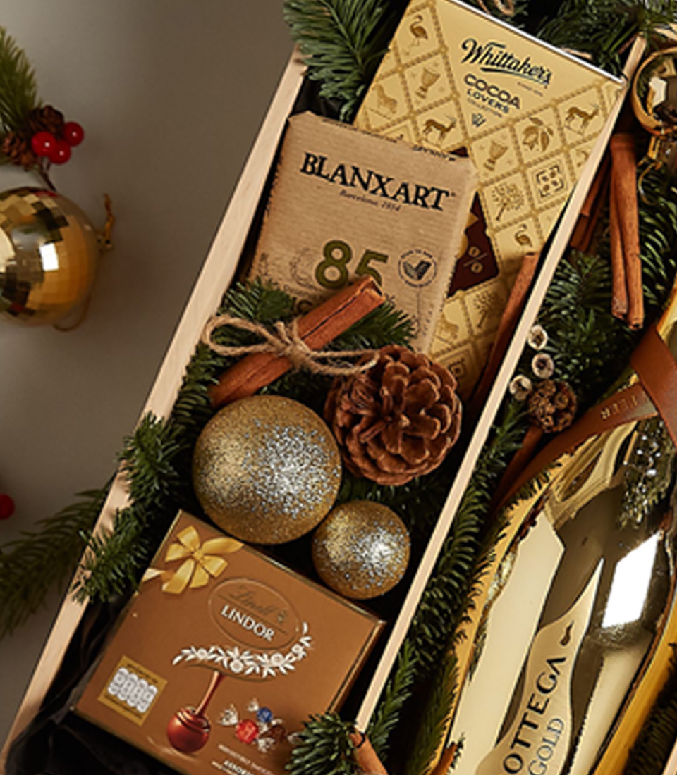 Luxurious holiday gift tray with fresh berries, chocolates, and festive gold accents for a memorable celebration.