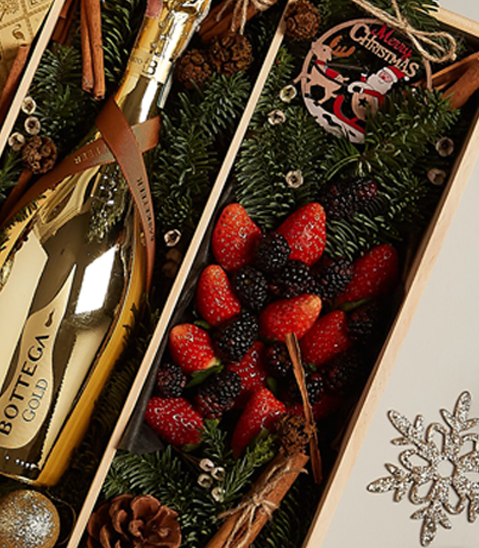 Luxurious holiday gift tray with fresh berries, chocolates, and festive gold accents for a memorable celebration.
