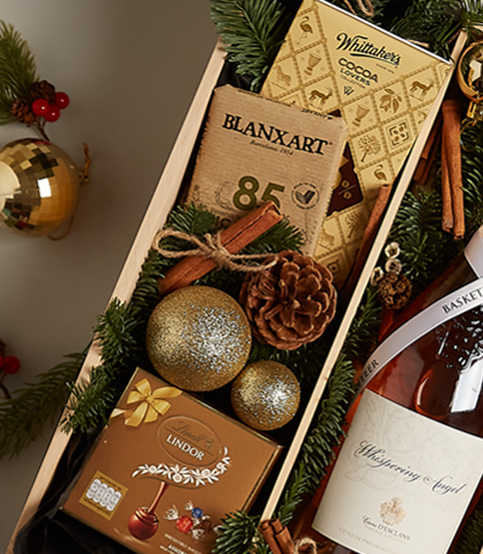 Elegant holiday gift tray with fresh berries, chocolates, and a festive design for a special celebration.