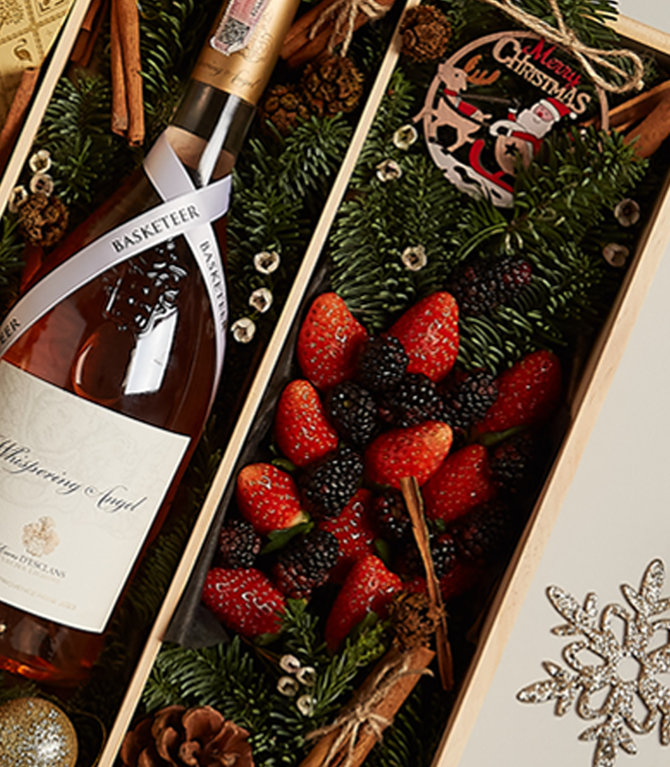 Elegant holiday gift tray with fresh berries, chocolates, and a festive design for a special celebration.