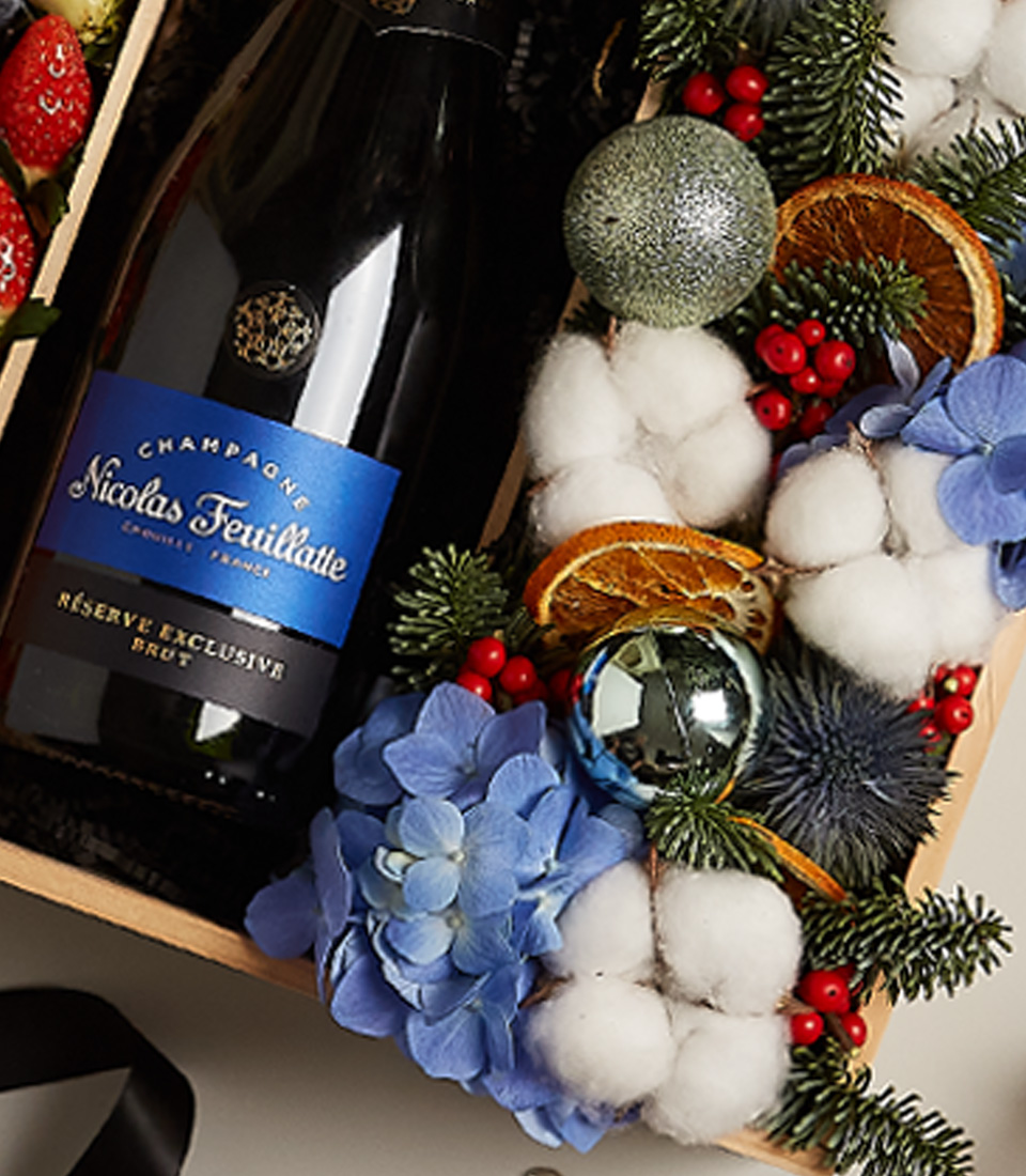 Elegant holiday gift tray with strawberries, blueberries, and festive floral decor for special celebrations.