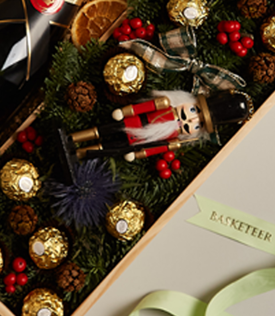 Holiday gift box with nutcrackers, festive decorations, and premium treats for a luxurious celebration.