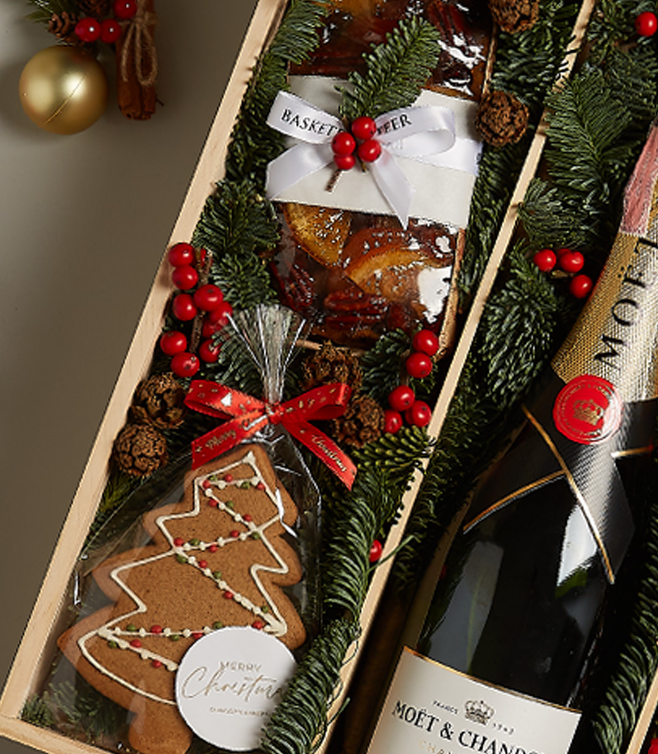 Elegant holiday gift box with chocolates, festive treats, and seasonal decorations for a memorable celebration.