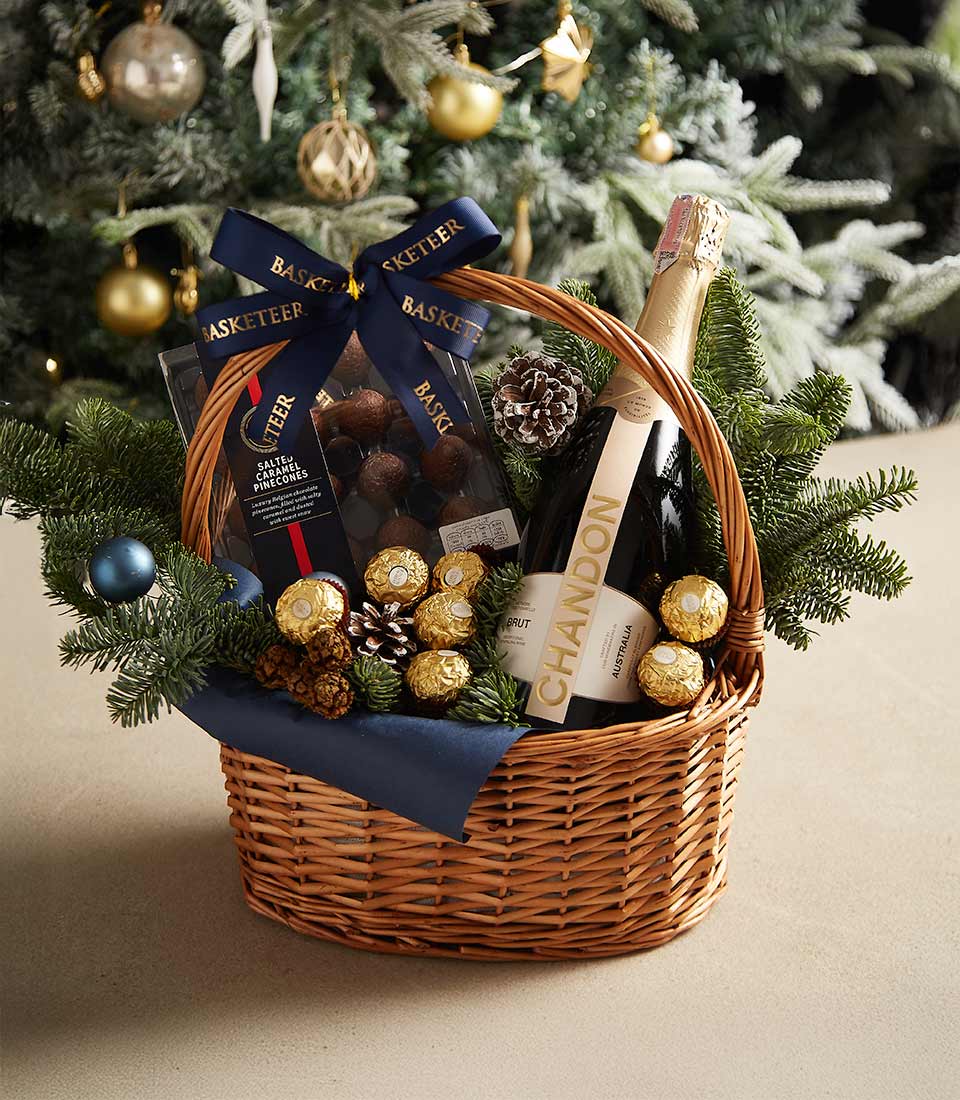 Holiday gift basket with blue ribbon, festive greenery, and premium treats for a perfect seasonal gift.