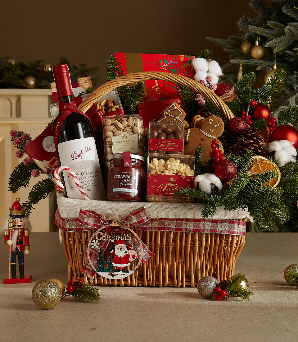 Festive wicker basket with Penfolds wine, Walkers shortbread, strawberry jam, gingerbread cookie, and holiday-themed gourmet treats.