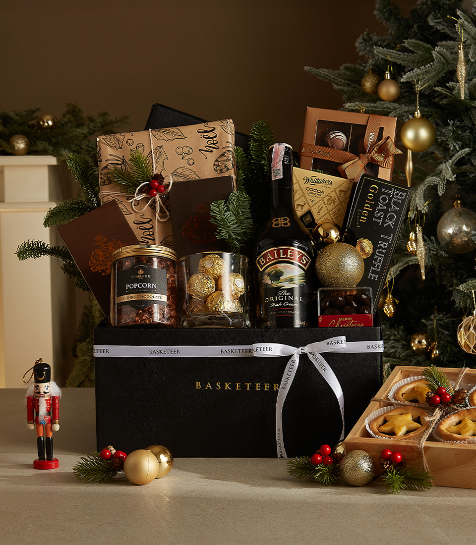 Sophisticated black box Christmas hamper featuring Bailey's Irish Cream, truffle toast, popcorn, chocolates, and festive decorations.