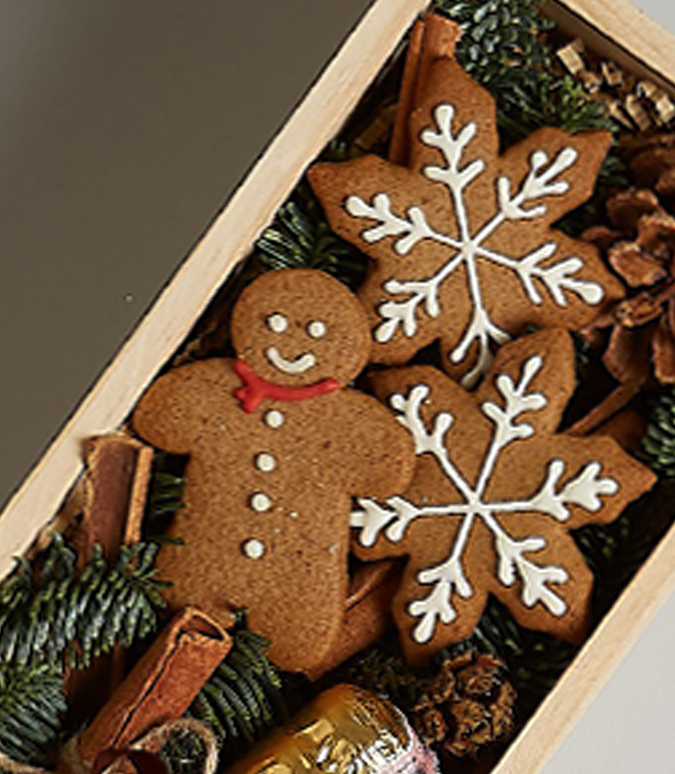 Holiday gift box with Bottega Gold Prosecco, gingerbread cookies, snowflake ornaments, and festive decorations.