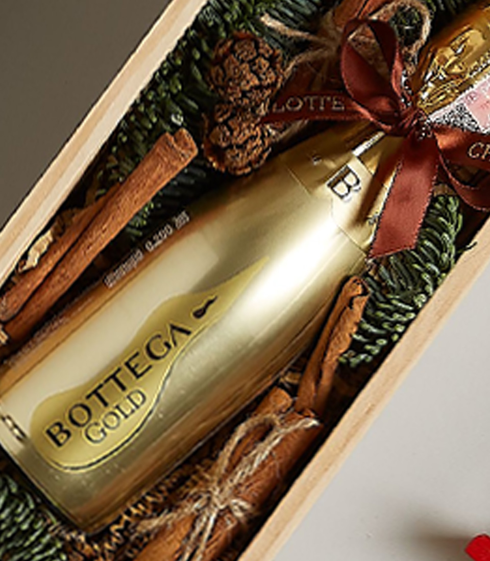 Holiday gift box with Bottega Gold Prosecco, gingerbread cookies, snowflake ornaments, and festive decorations.