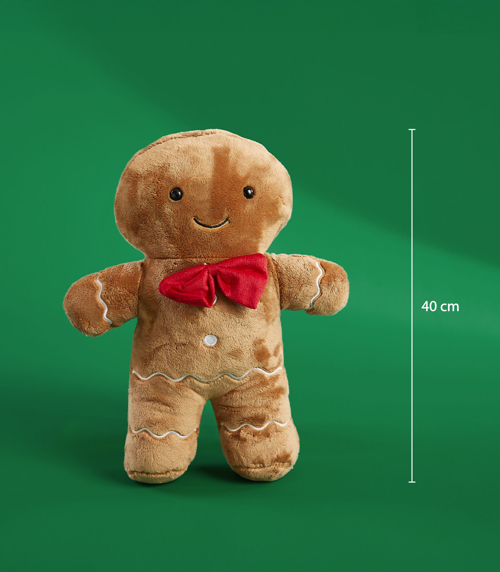 Adorable 40 cm gingerbread man plush toy with a red bow on a green background.