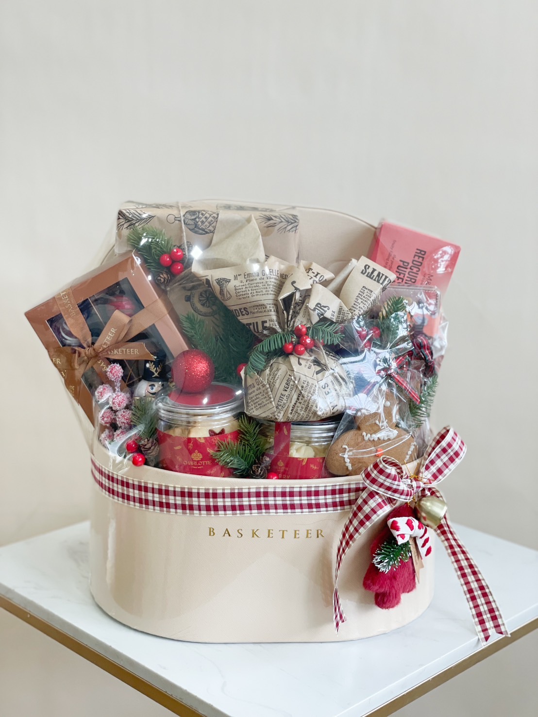 Elegant Christmas gift basket filled with holiday treats, chocolates, cookies, and a festive ribbon.