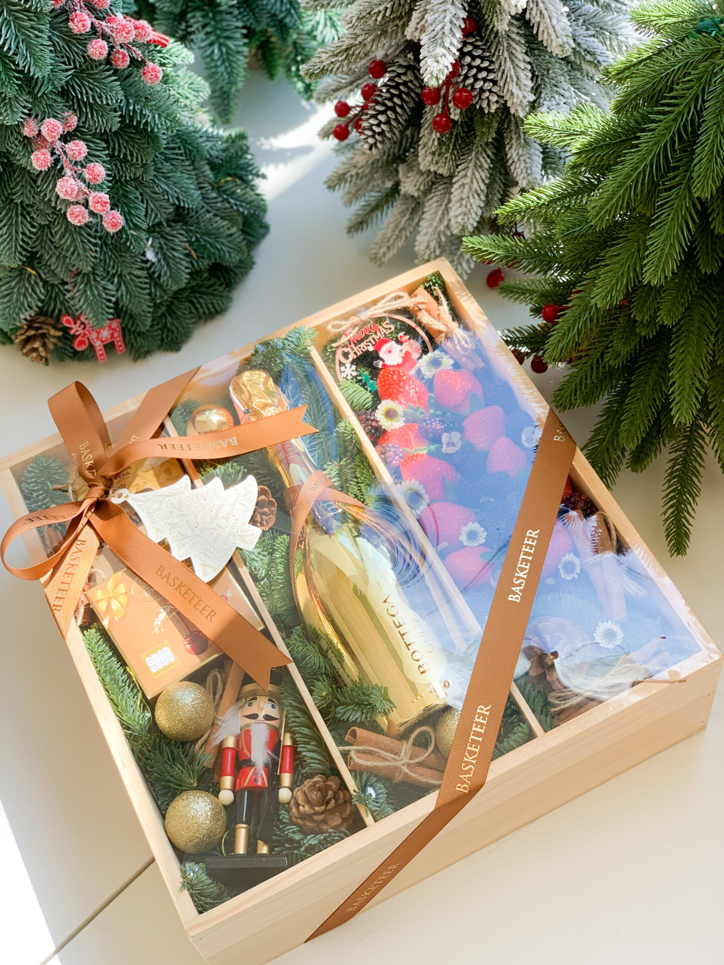 Luxurious holiday gift tray with fresh berries, chocolates, and festive gold accents for a memorable celebration.