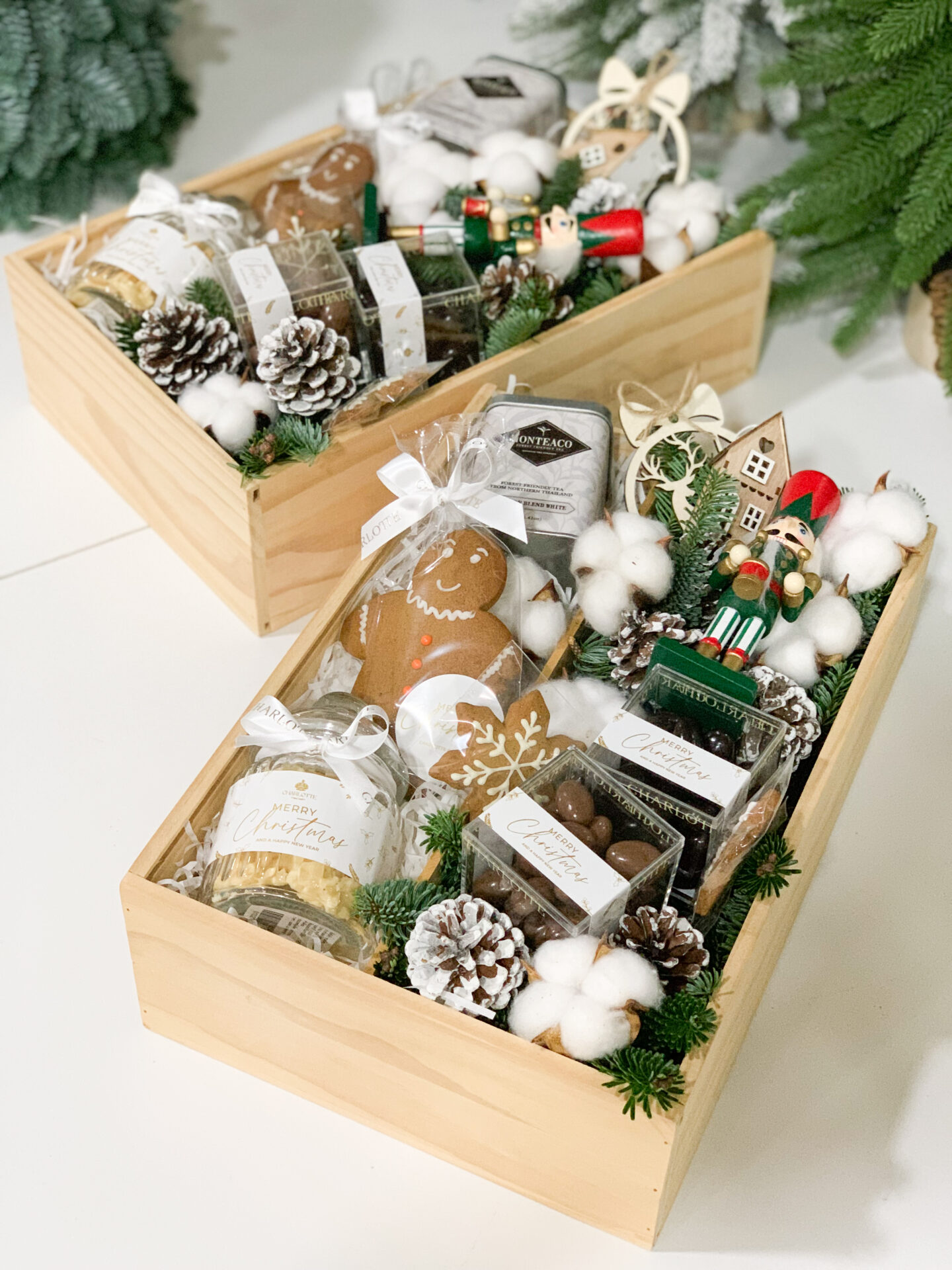 Winter-themed gourmet gift box with cookies, chocolates, hot cocoa, and festive holiday decorations.