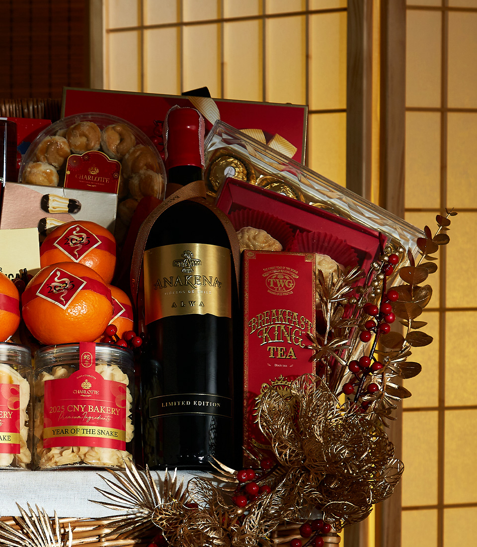 Close-up of Golden Prosperity Chinese New Year gift hamper with premium wine, gourmet treats, festive fruits, and elegant decorations.