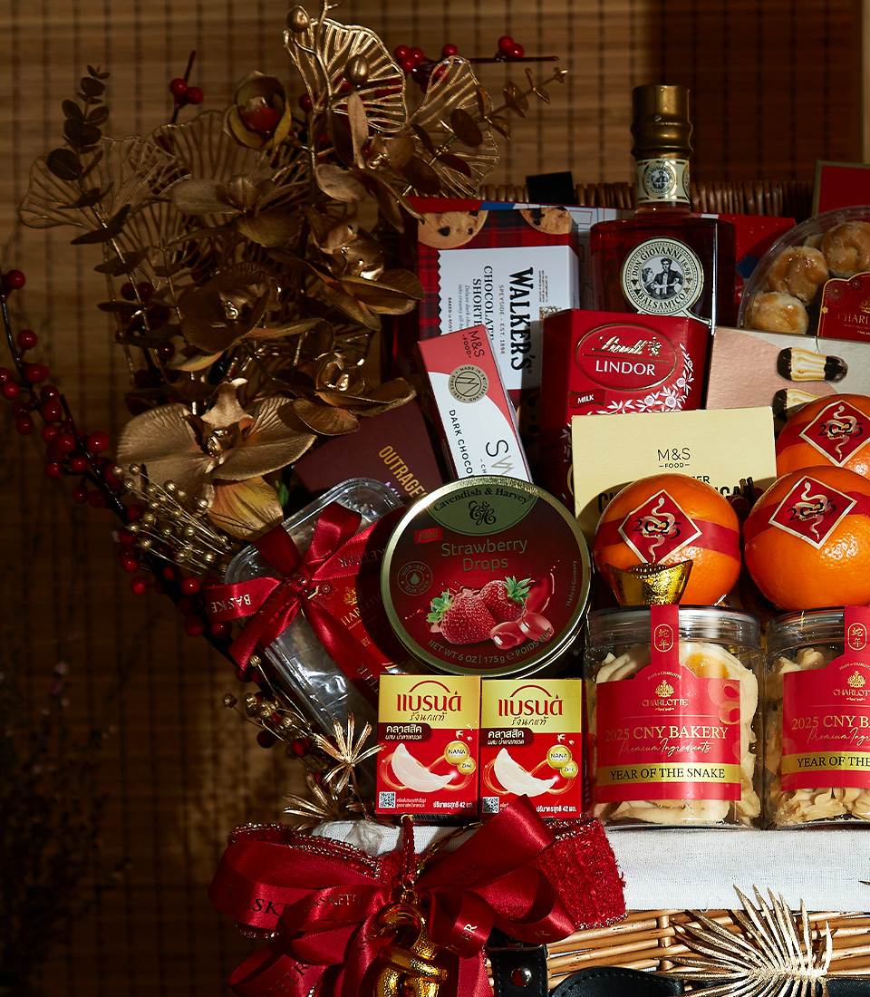 Close-up of Golden Prosperity Chinese New Year gift hamper with premium wine, gourmet treats, festive fruits, and elegant decorations.