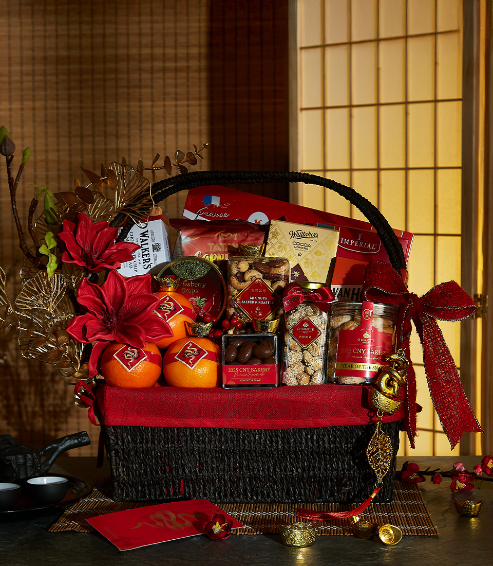 Lunar New Year gift basket with red and gold accents, filled with premium snacks, fresh oranges, and festive decorations