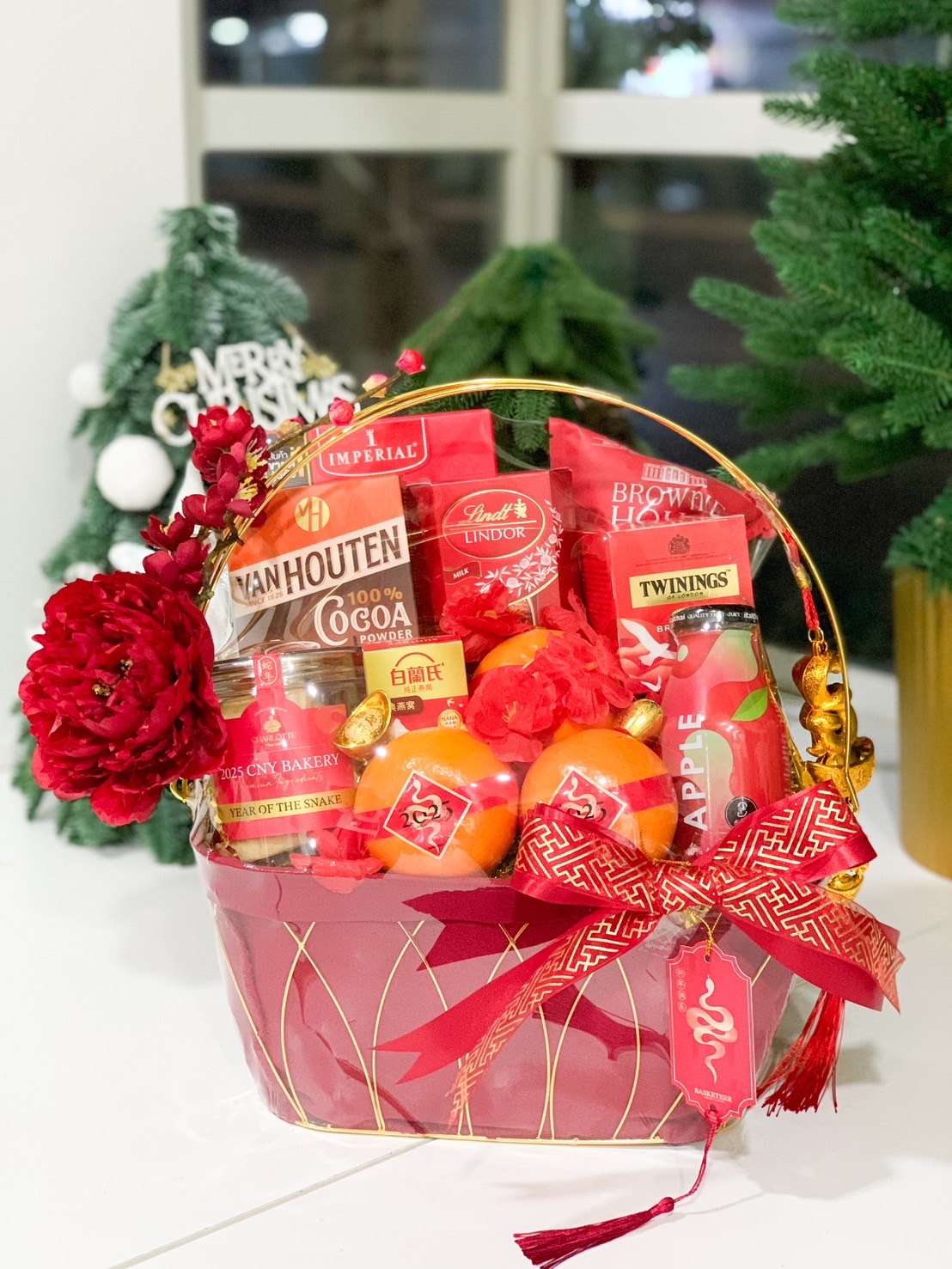 Deluxe Chinese New Year gift basket with premium oranges, chocolates, teas, and vibrant red decorations.