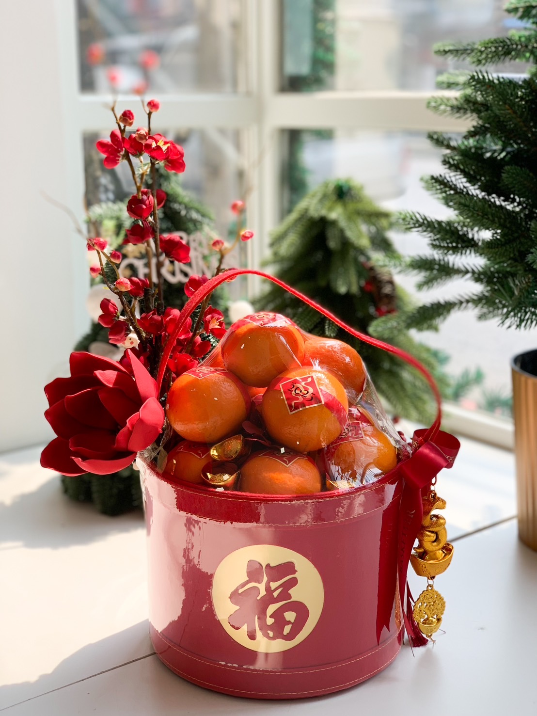 Lunar Luck Premium Basket featuring fresh oranges and festive florals in a red leather basket for Chinese New Year.