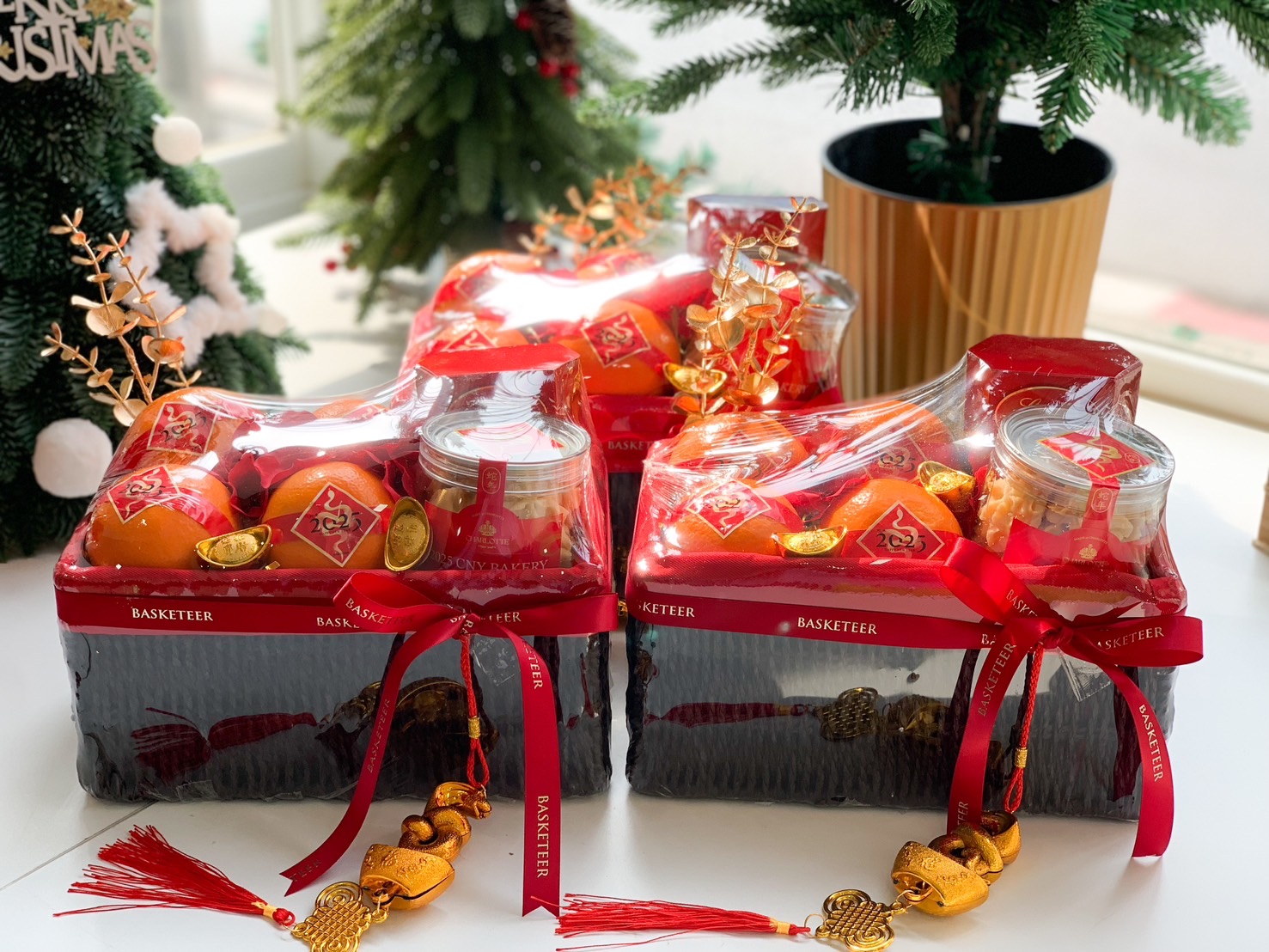 Luxurious Lunar New Year gift basket with premium oranges, golden coins, festive snacks, and a red Basketeer ribbon.