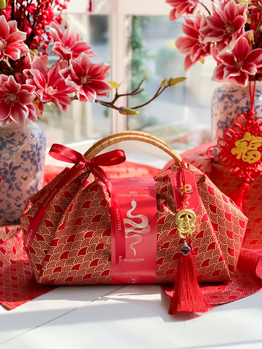 Luxury Chinese New Year fortune gift bag with red and gold fabric, traditional handle, and festive lucky charm for prosperity and celebration.