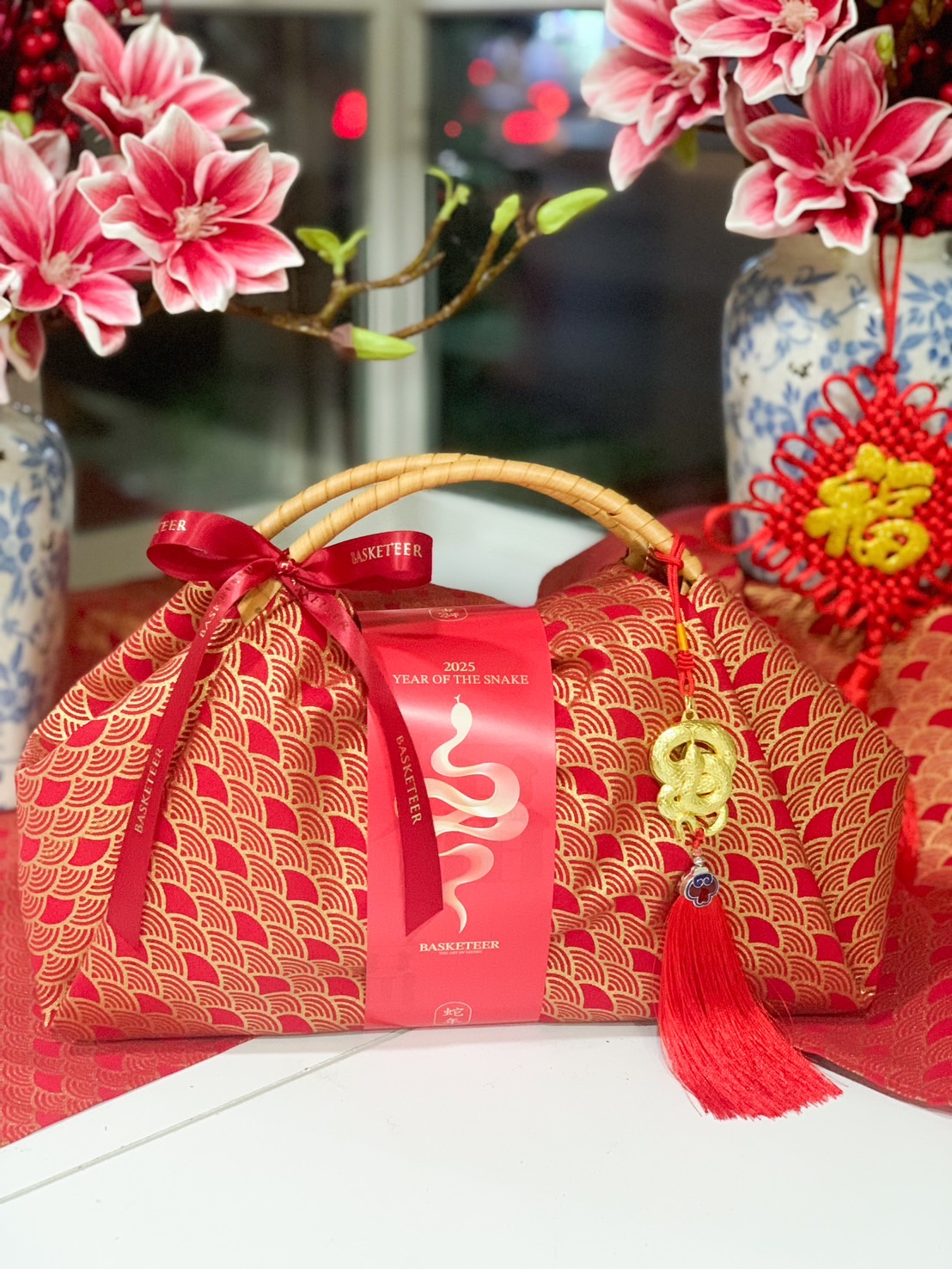 Luxury Chinese New Year fortune gift bag with red and gold fabric, traditional handle, and festive lucky charm for prosperity and celebration.