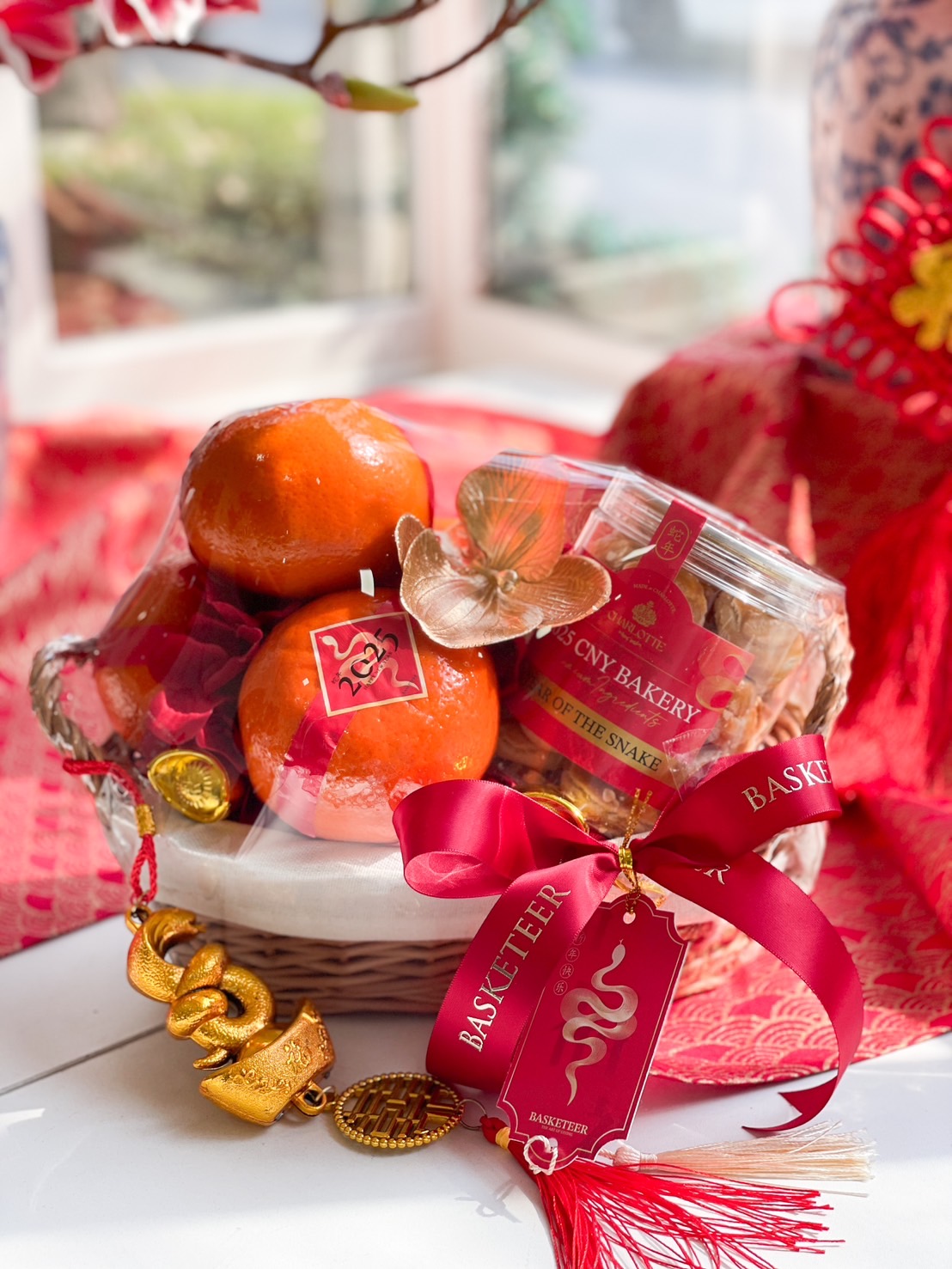 Chinese New Year Prosperity Orange Basket with fresh oranges and premium cookies in festive red decor.