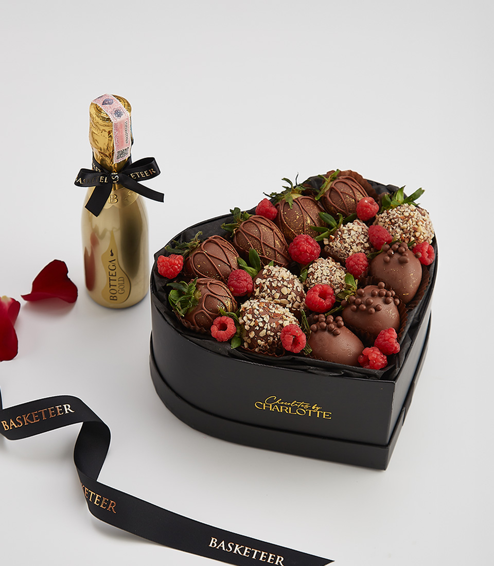 Heart-shaped gift box with dark chocolate-covered strawberries, raspberries, and a bottle of Bottega Gold prosecco.