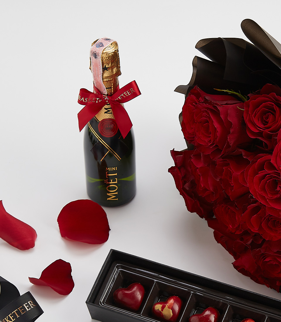 Moët champagne with heart chocolates and red roses – a luxury romantic gift set.