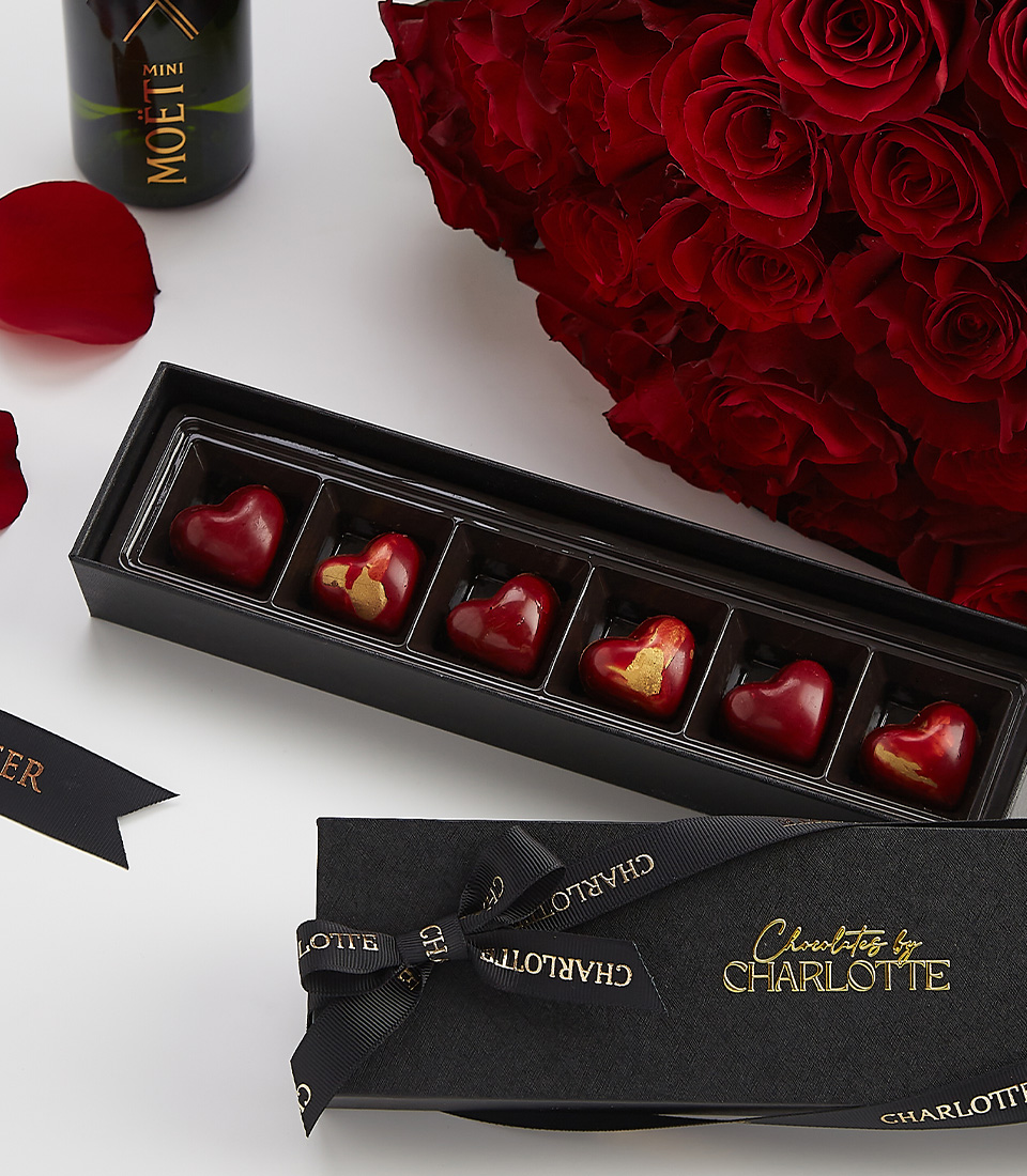 Moët champagne with heart chocolates and red roses – a luxury romantic gift set.