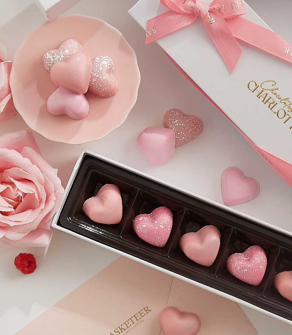 Close-up of a beautifully boxed set of pink heart chocolates, ideal for Valentine’s gifting, featuring a luxurious design with romantic touches.