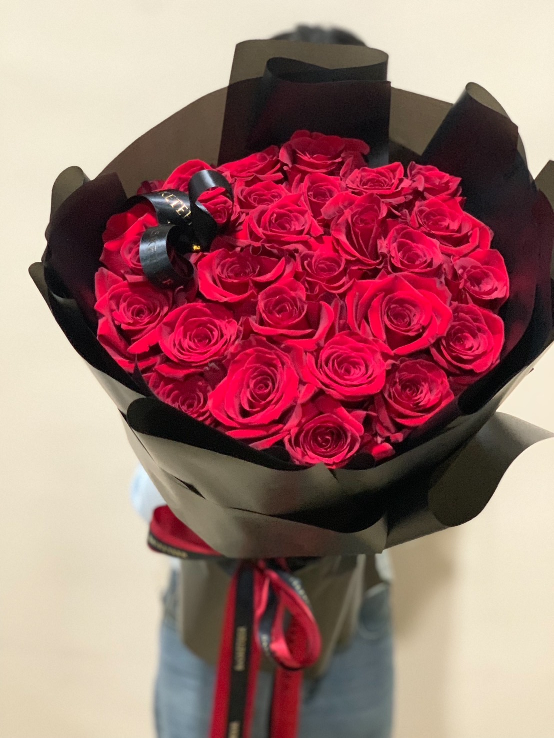 A luxurious bouquet of 50 deep red roses wrapped in black paper with matching ribbons. Perfect for romantic occasions like Valentine’s Day, anniversaries, and love declarations.