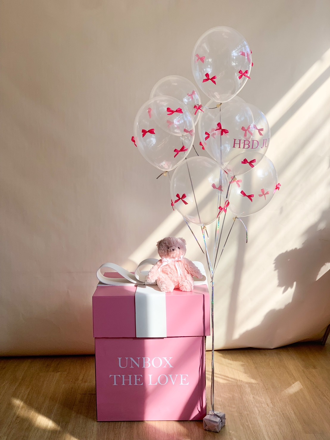 A beautiful pink and white birthday surprise gift box labeled 