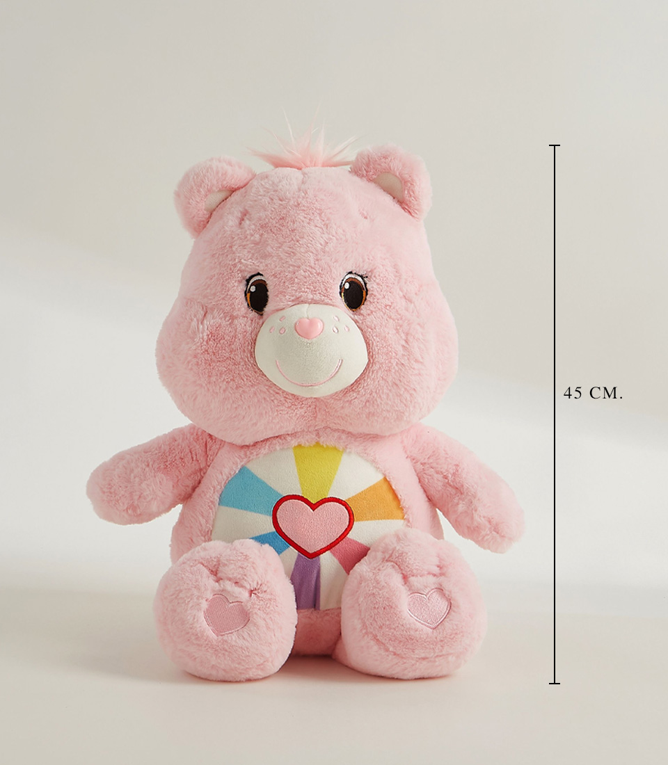 A cute pink plush bear with a rainbow heart design on its belly, soft fur, embroidered heart-shaped paws, and a sweet smile.
