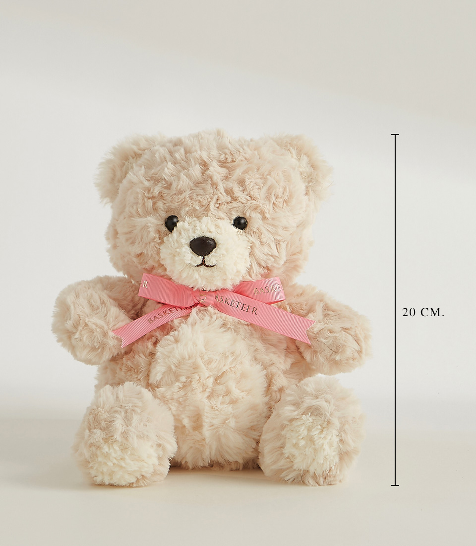 Soft beige teddy bear with a pink ribbon, featuring a plush and huggable design, perfect for gifts and cuddles.