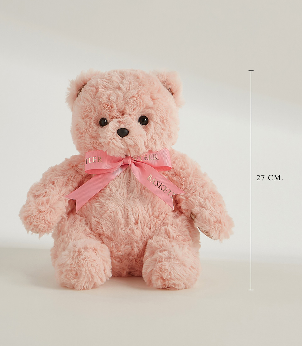 A fluffy pink teddy bear adorned with a pink bow featuring the words 