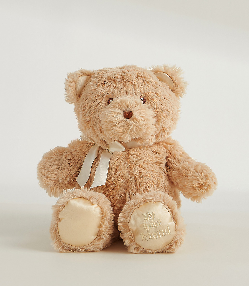 Soft golden plush teddy bear with a satin ribbon and embroidered 