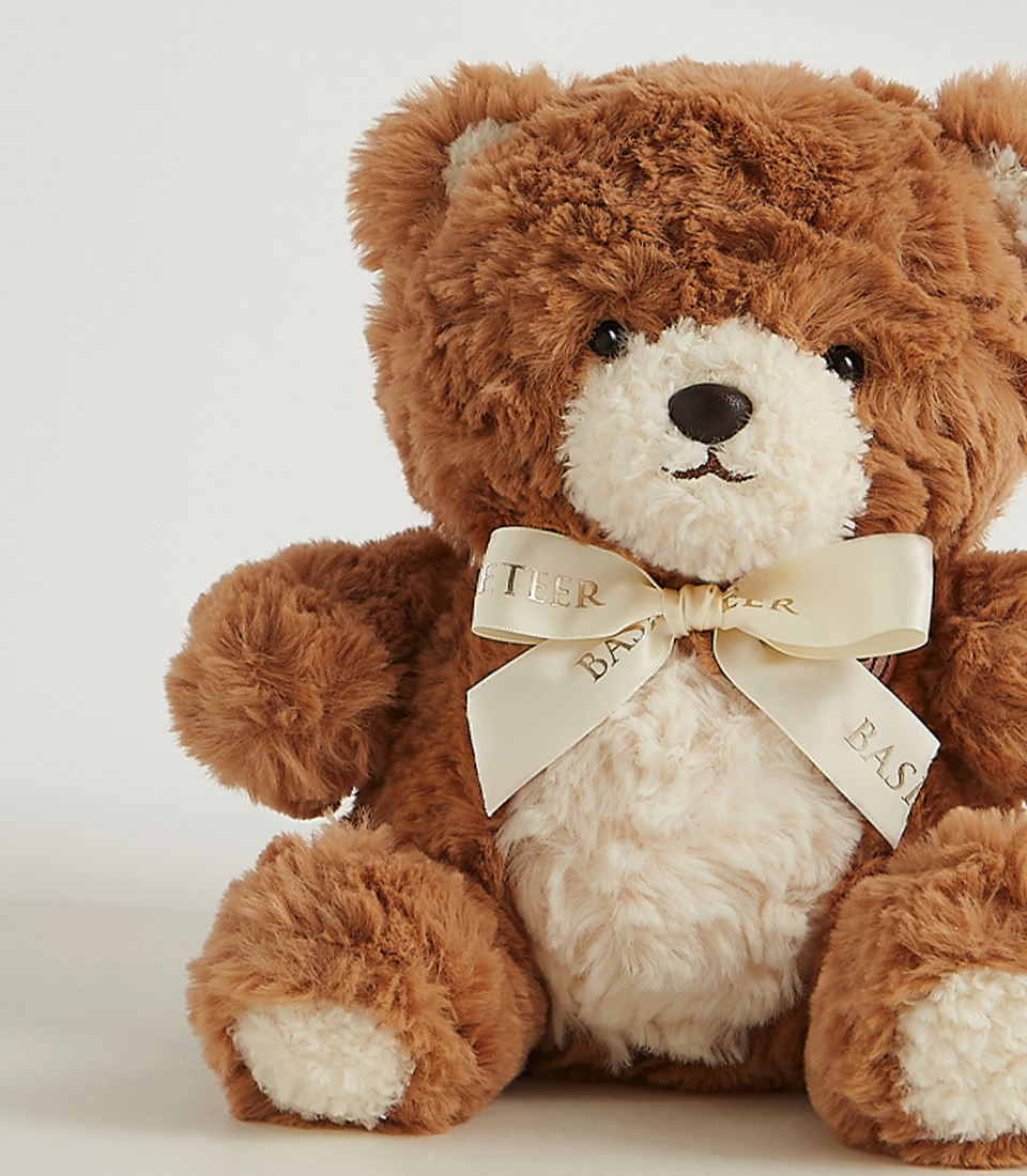 Soft brown plush teddy bear with a creamy white belly and an elegant satin ribbon, perfect for cuddles and heartfelt gifts.