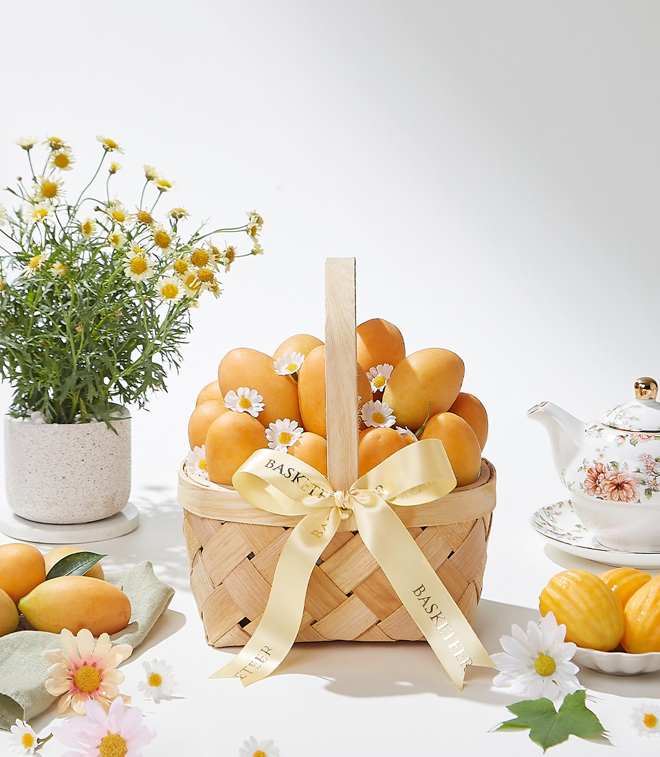A beautifully arranged woven basket filled with 1.5 kg of Premium Mayongchid (Marian Plum), decorated with white daisy flowers and a golden satin ribbon—a luxurious and fresh fruit gift for any occasion.