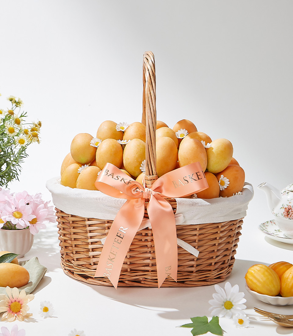 An opulent handwoven wicker basket, gracefully adorned with pristine white daisies and an elegant satin ribbon, filled with 2 kg of the finest, sun-kissed Mayongchid (Marian Plum)—a true symbol of luxury and exclusivity.