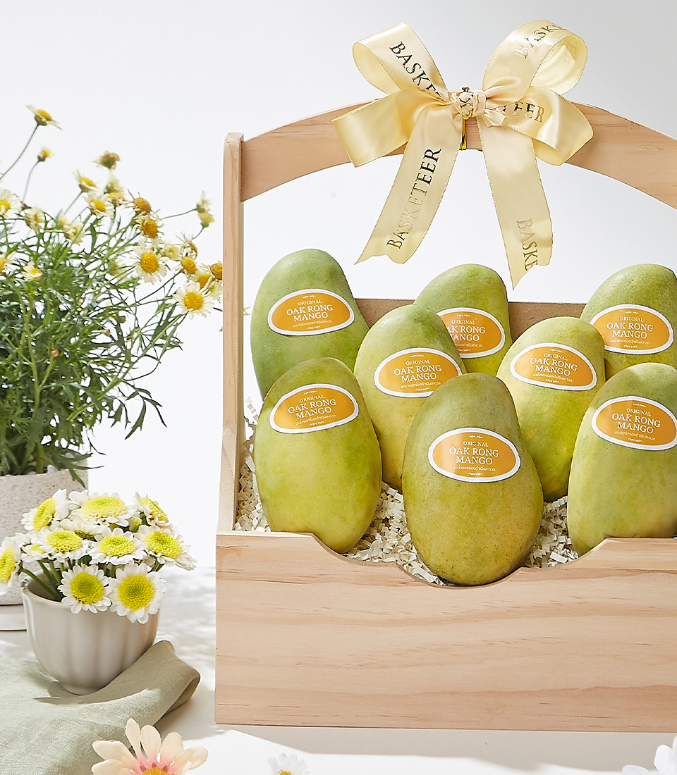 A beautifully handcrafted woven basket filled with premium Mayongchid (Marian Plum) fruit, elegantly decorated with a satin ribbon, exuding sweet tropical flavors and a delicate aroma.