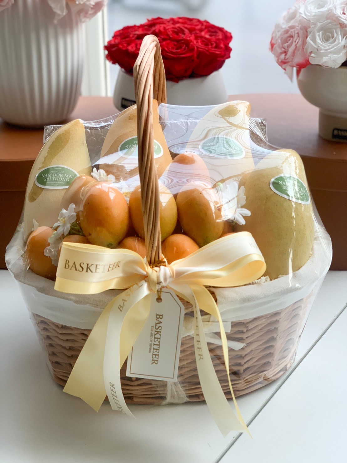 Premium Nam Dok Mai mango gift basket with golden ribbon from Basketeer.