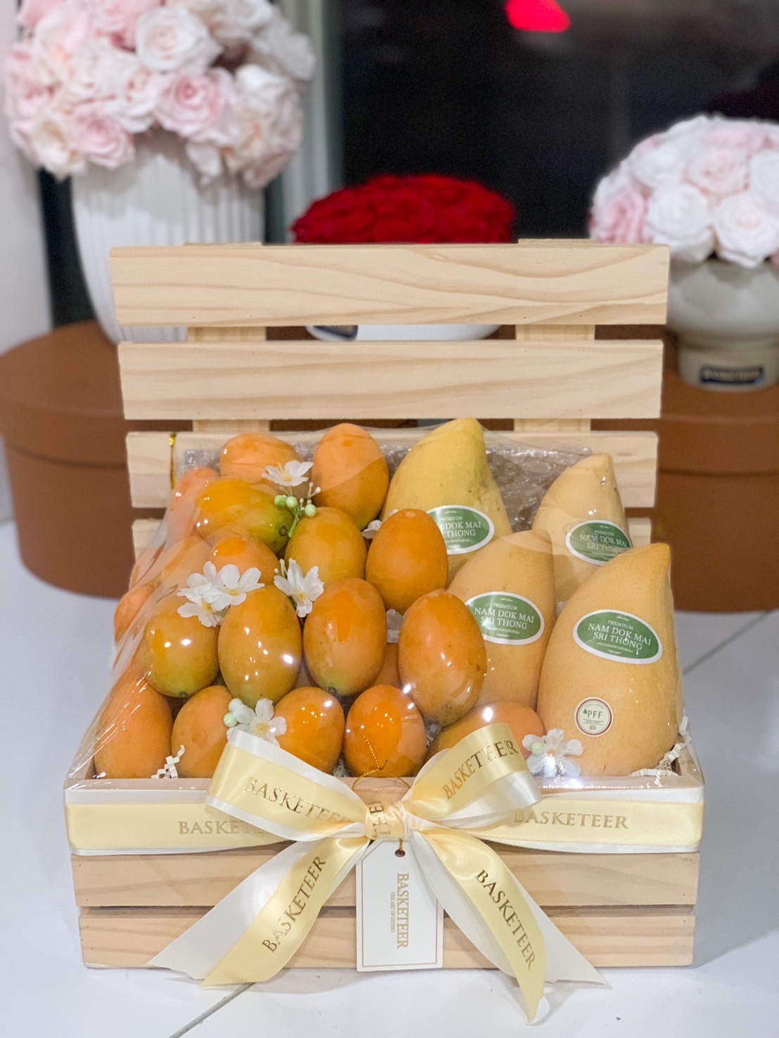 Premium Thai mangoes and marian plums in an elegant wooden gift crate.
