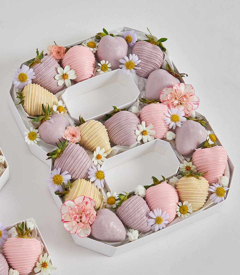 Number 8 gift box with pastel chocolate strawberries and fresh flowers in soft pink, lavender, cream, and white tones
