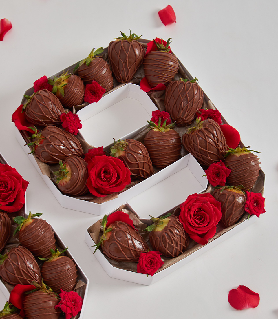 Close-up of number 8 gift box with chocolate strawberries and red roses, perfect for romantic occasions