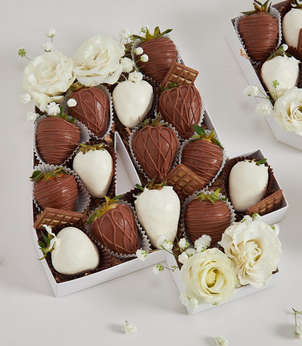 Number 45 box with white and milk chocolate strawberries, white roses, chocolate wafers, and baby’s breath on white background