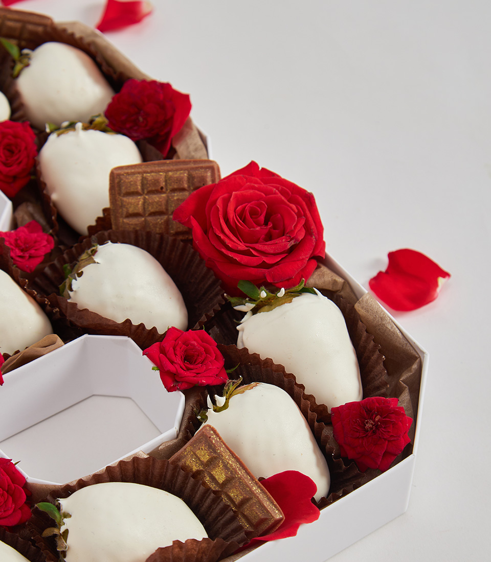 Close-up of white chocolate strawberries in number 3 box with red roses