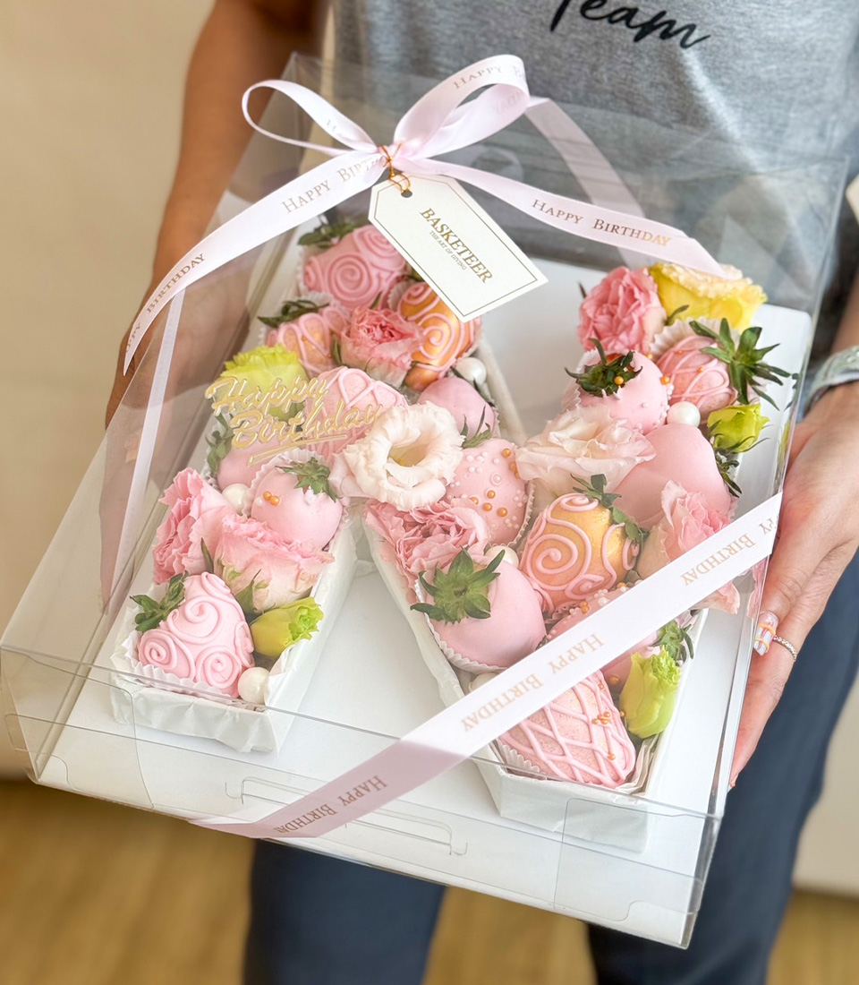 Pink letter N gift box with chocolate strawberries and flowers
