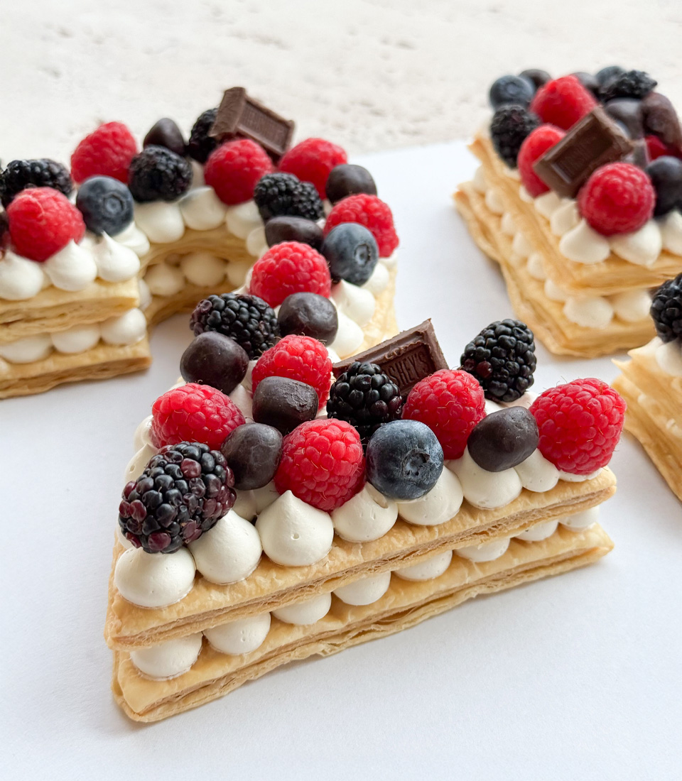 Number 25 puff pie cake topped with fresh berries and chocolates