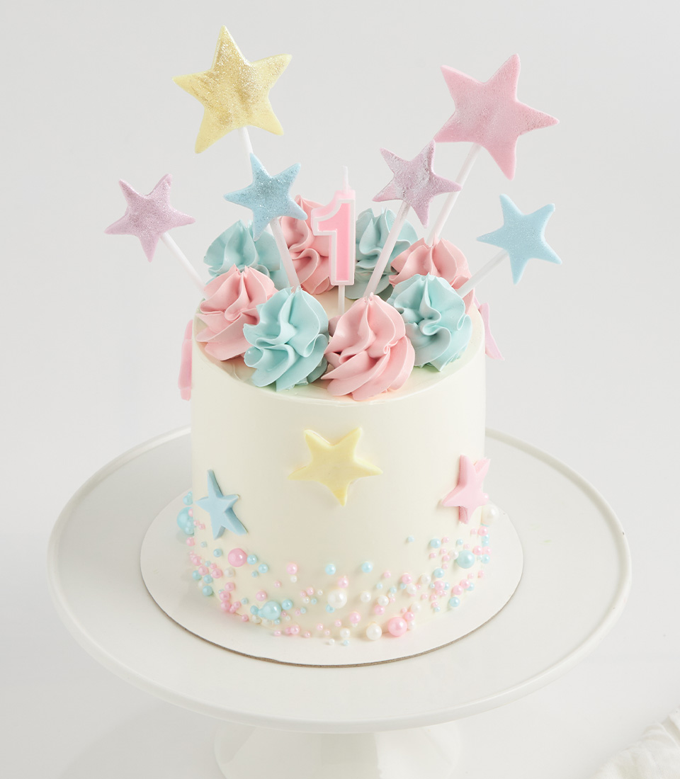 Vanilla birthday cake with pastel stars, buttercream swirls and pearl sprinkles