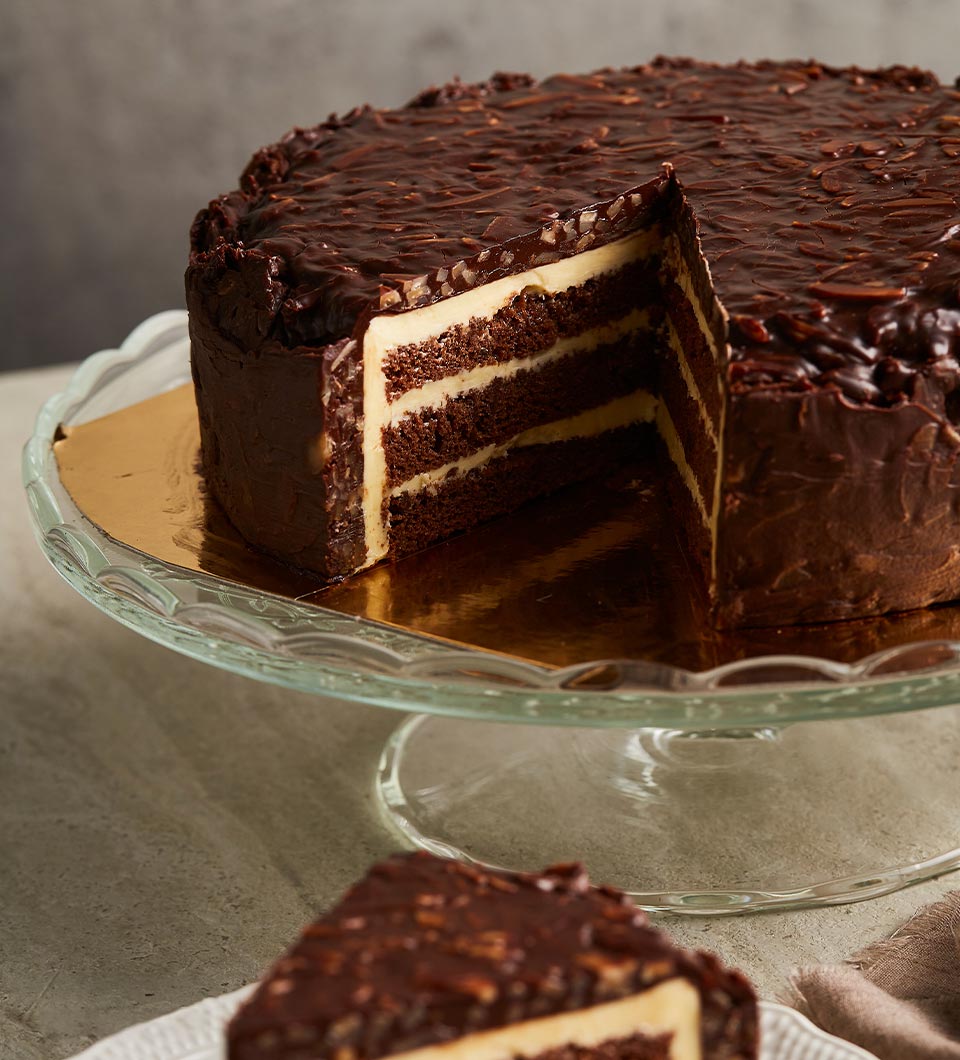 A rich chocolate layer cake with cream filling and hazelnut chocolate ganache